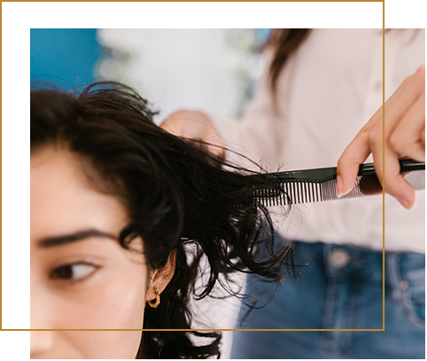 A woman getting the hair cut done